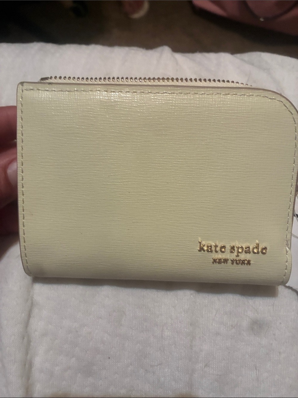 kate spade cream bifold wallet with gold logo